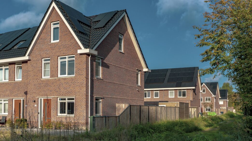 brown brick building near green grass field during daytime