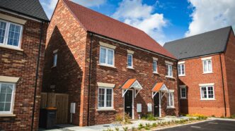 brown brick house under blue sky during daytime